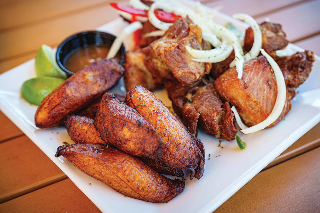 Masita de puerco—a fried pork dish—with plantains