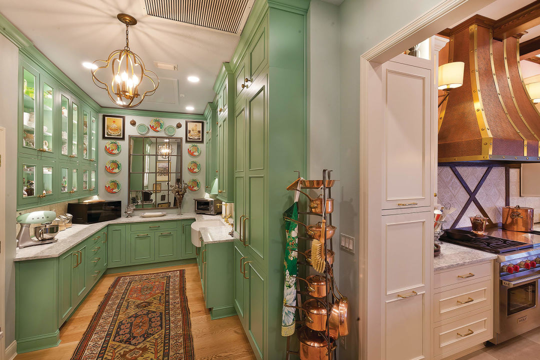 A scullery kitchen adjacent to the main kitchen hides messy food prep and offers extra storage.
