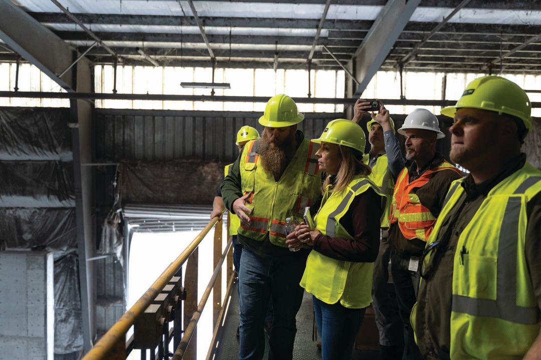 Author Stephanie Churn Lubow (center, in profile) tours a Waste Pro facility in Manatee County that processes recycling from the City of Sarasota.