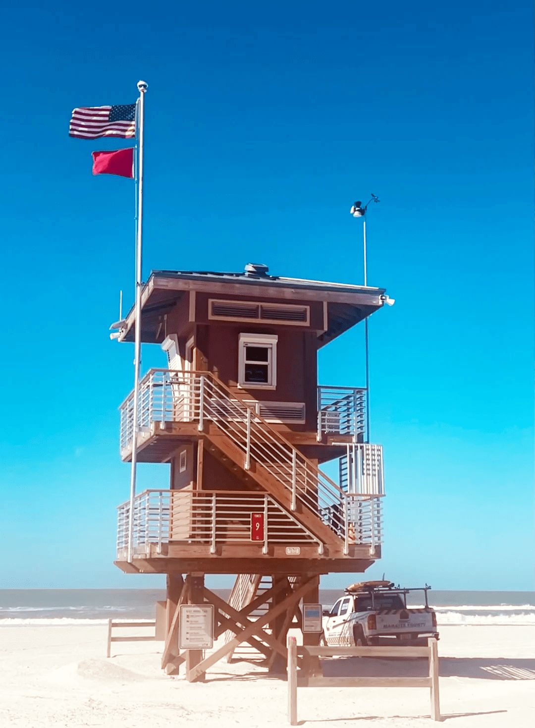 A lifeguard tower at an area beach. Pay close attention to the flag color: red means swimming conditions are high hazard.