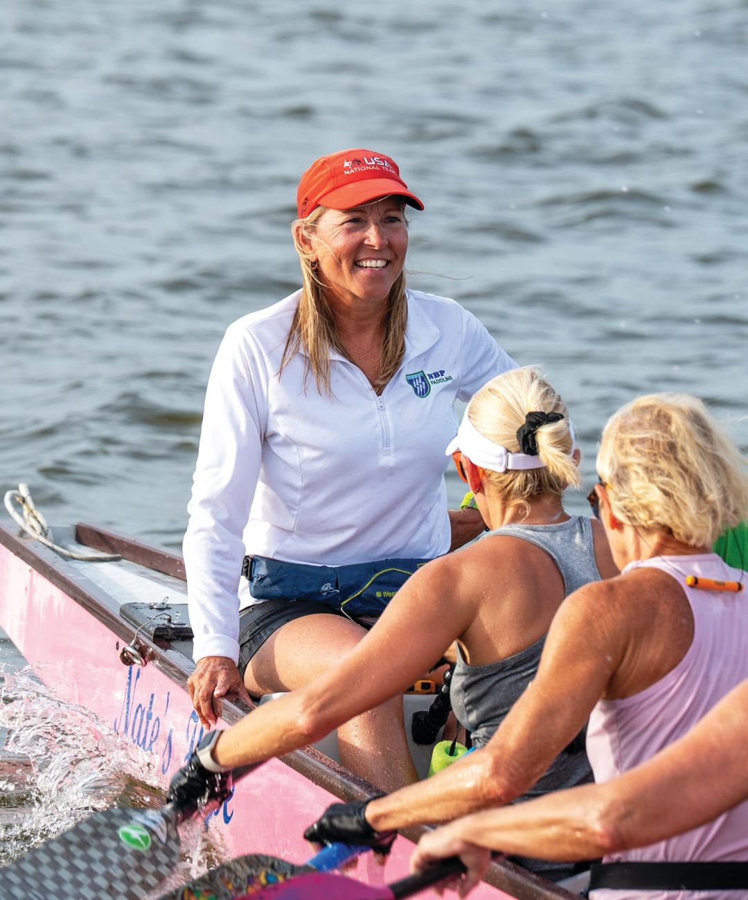 Coach Angela Long with her team at Nathan Benderson Park.