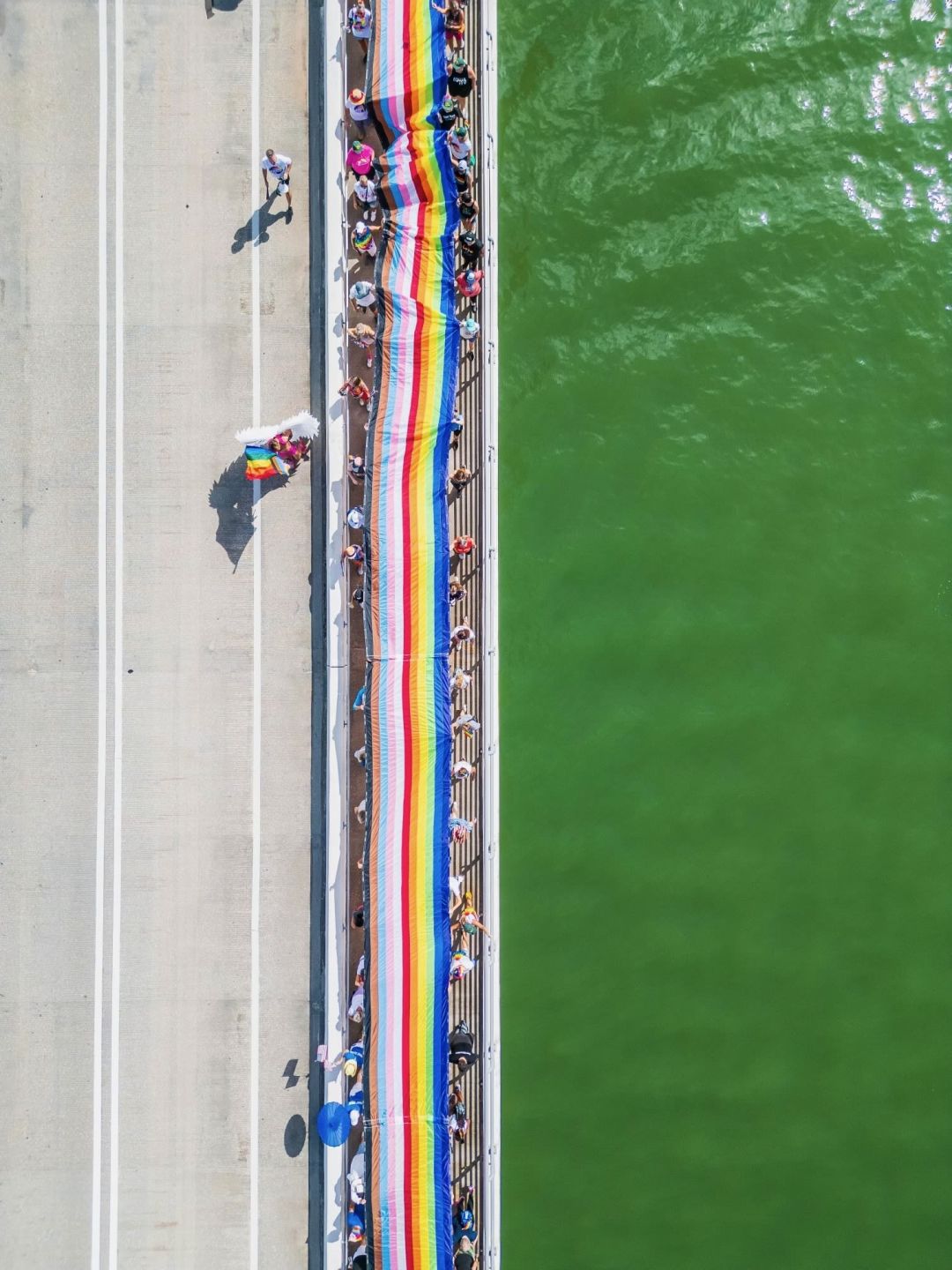 Community members walked Project Pride's 700-foot-long progressive pride flag across the John Ringling Bridge on Saturday morning, June 29, 2024.