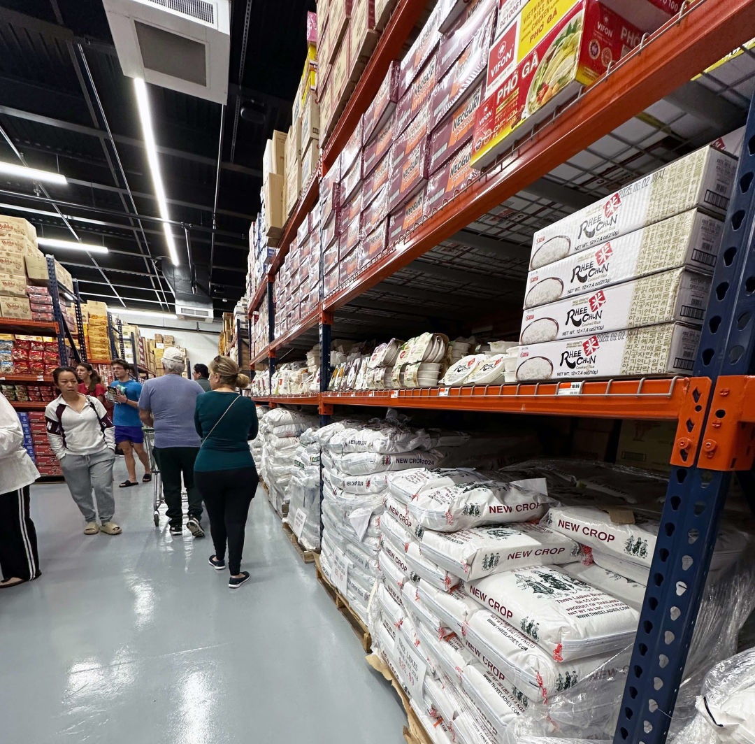 Customers check out the packed shelves of ingredients.