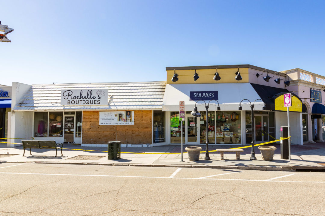 The street view of a closed strip of businesses on St. Armands Circle, Sarasota, Friday, Jan. 31, 2025. The sidewalk remains roped off, and businesses are boarded up due to water damage remodeling.