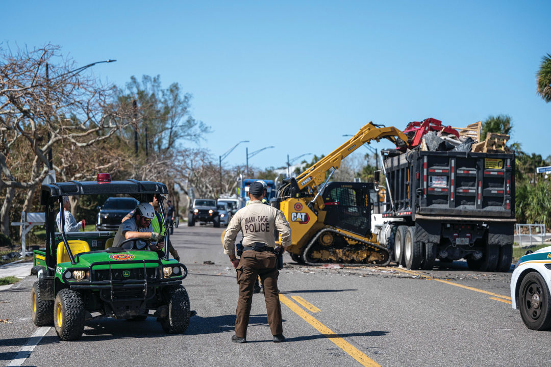 Police officers from Miami-Dade County were called into the area to assist with recovery; here, an officer helps direct traffic on Longboat Key.
