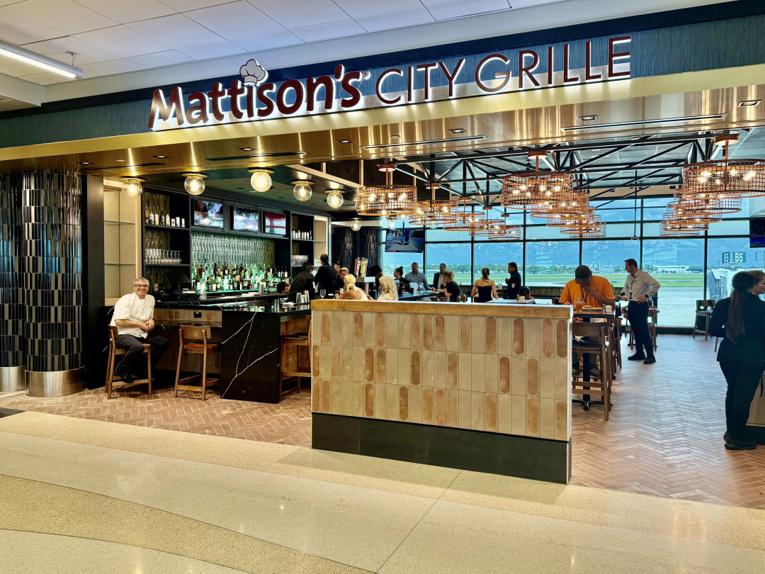 Chef Paul Mattison poses at the bar inside his newest Mattison's City Grille at Sarasota Manatee International Airport.