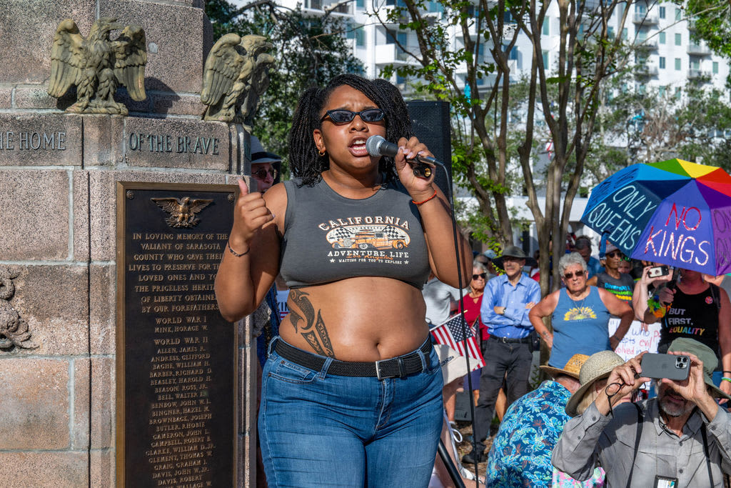 After rallying downtown, protestors marched over the Ringling Bridge holding a 700-foot pride flag.