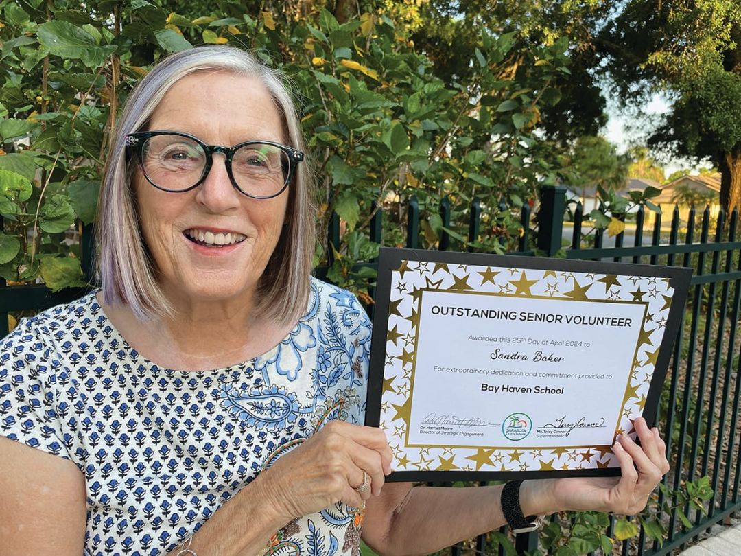 The author's mother, with a certificate recognizing her as "Outstanding Senior Volunteer" at a Sarasota school
