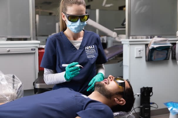 Dental Hygiene student working on a patient
