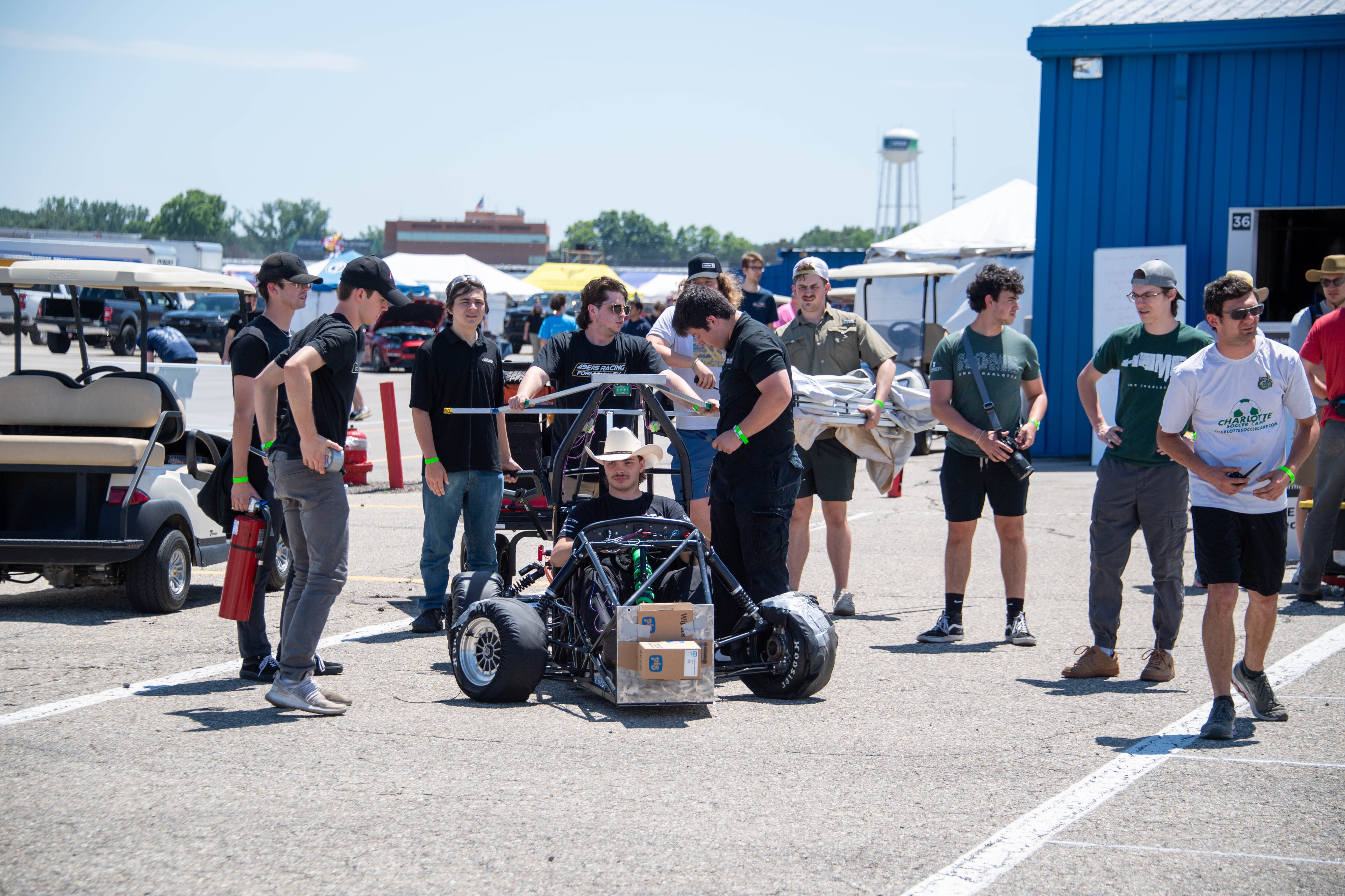 EV team standing around car at event