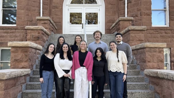 Group standing on the steps of Old Main
