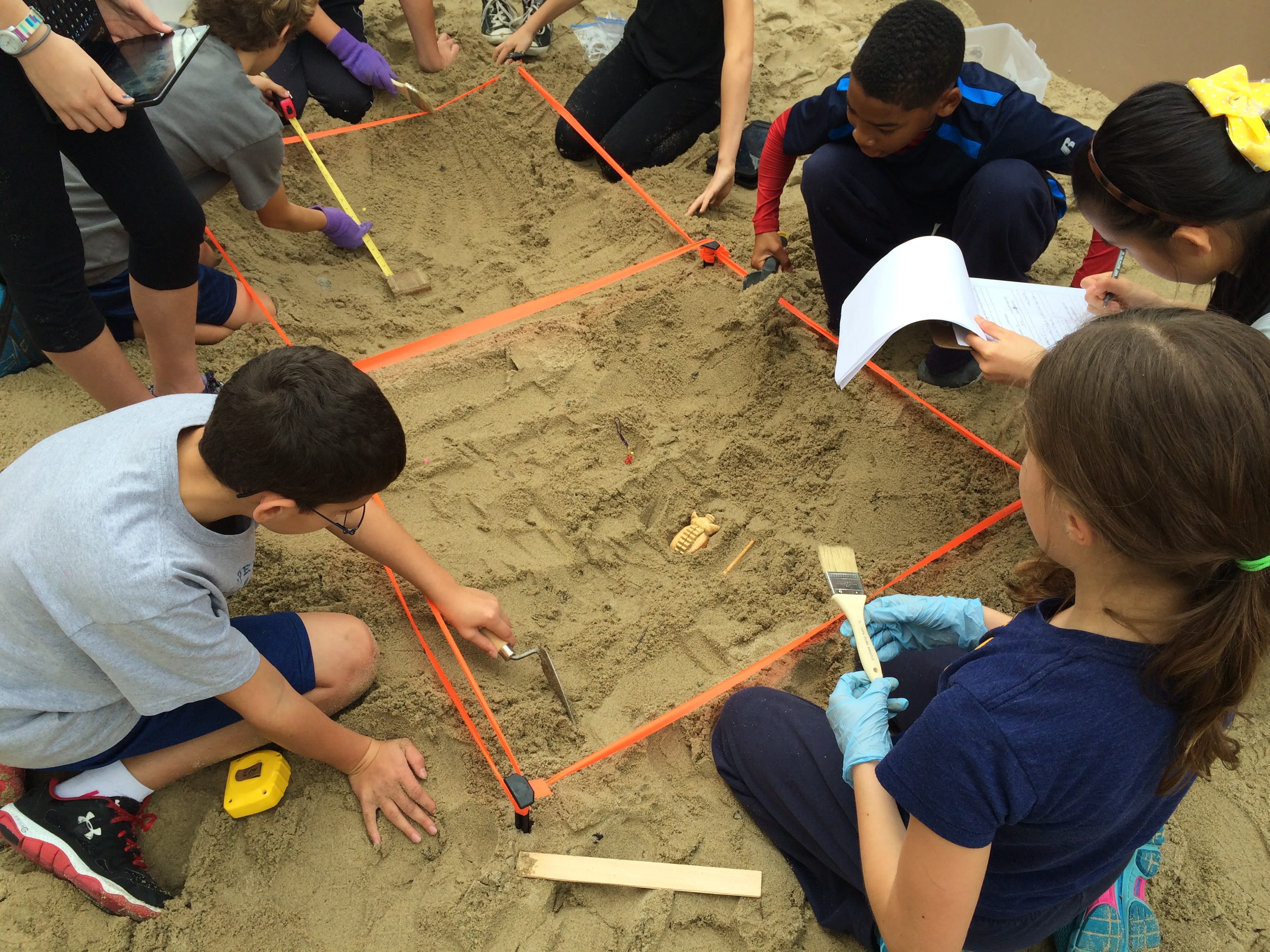 Children participate in an archaeological dig activity