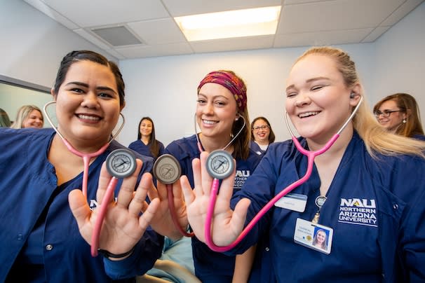 Student nurses posing with their stethoscopes