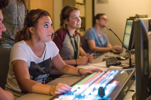 Communications students working a sound board