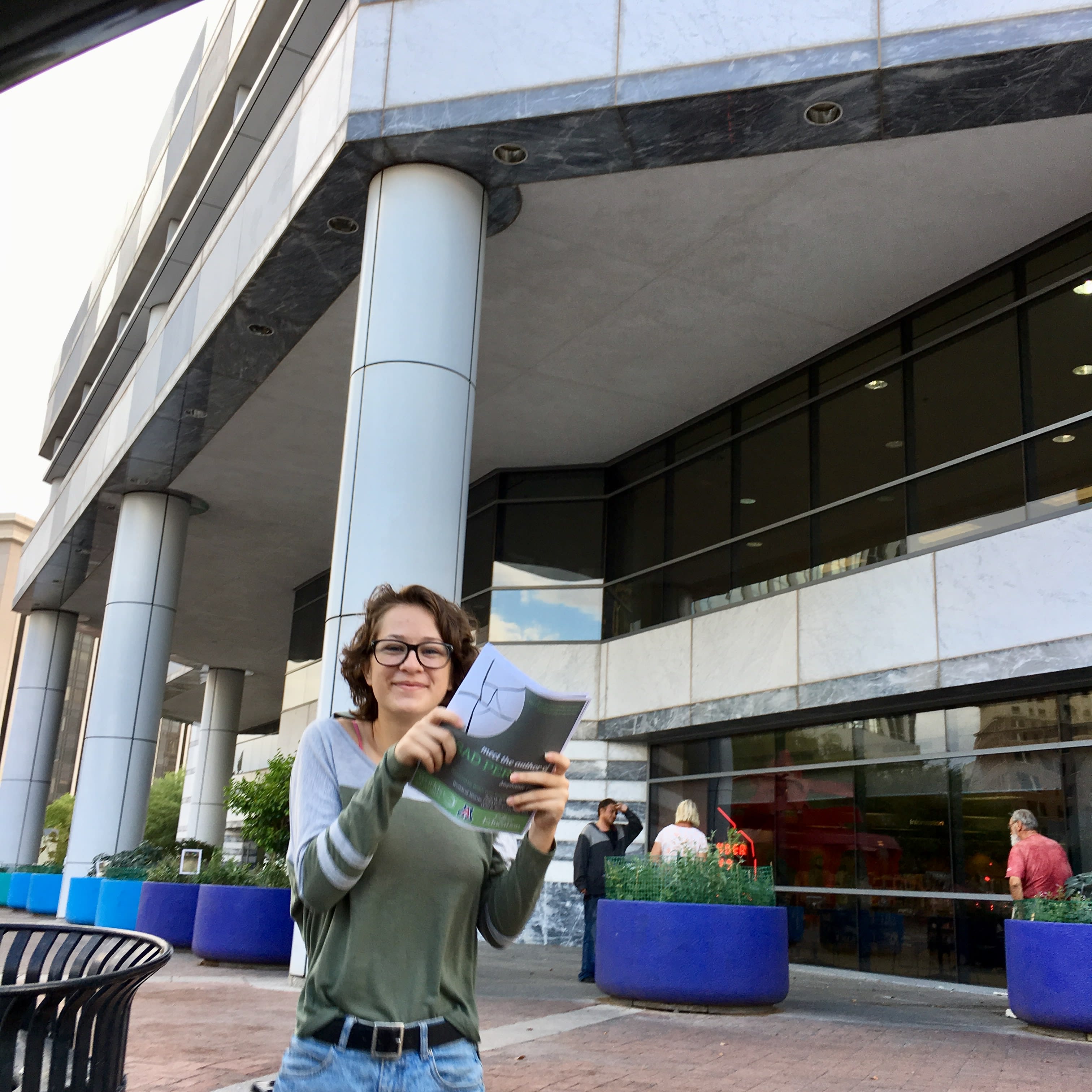 Teen distributing flyers to public library