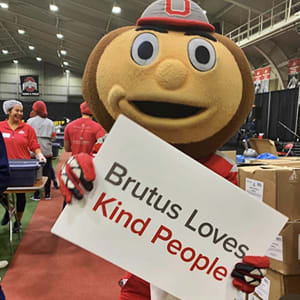 Brutus holds a sign that says Brutus loves kind people