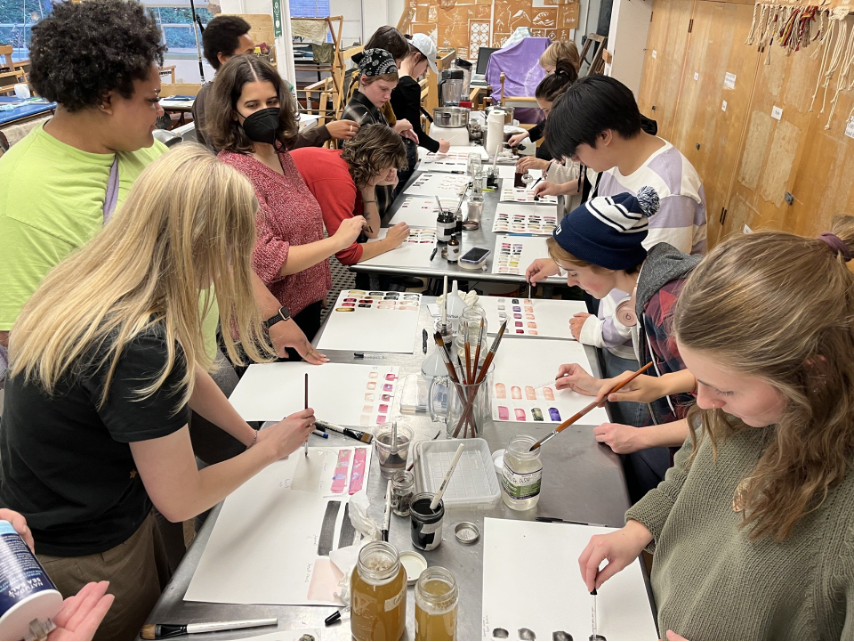 students in an arts and ecology class work on art