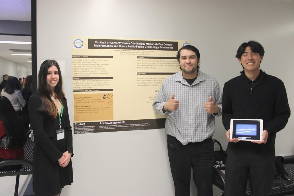 A group of people standing in front of a poster 
AI-generated content may be incorrect.