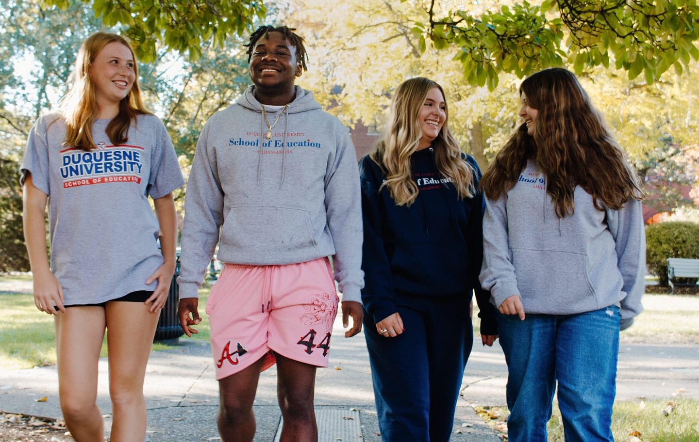 Education student ambassadors walking and smiling