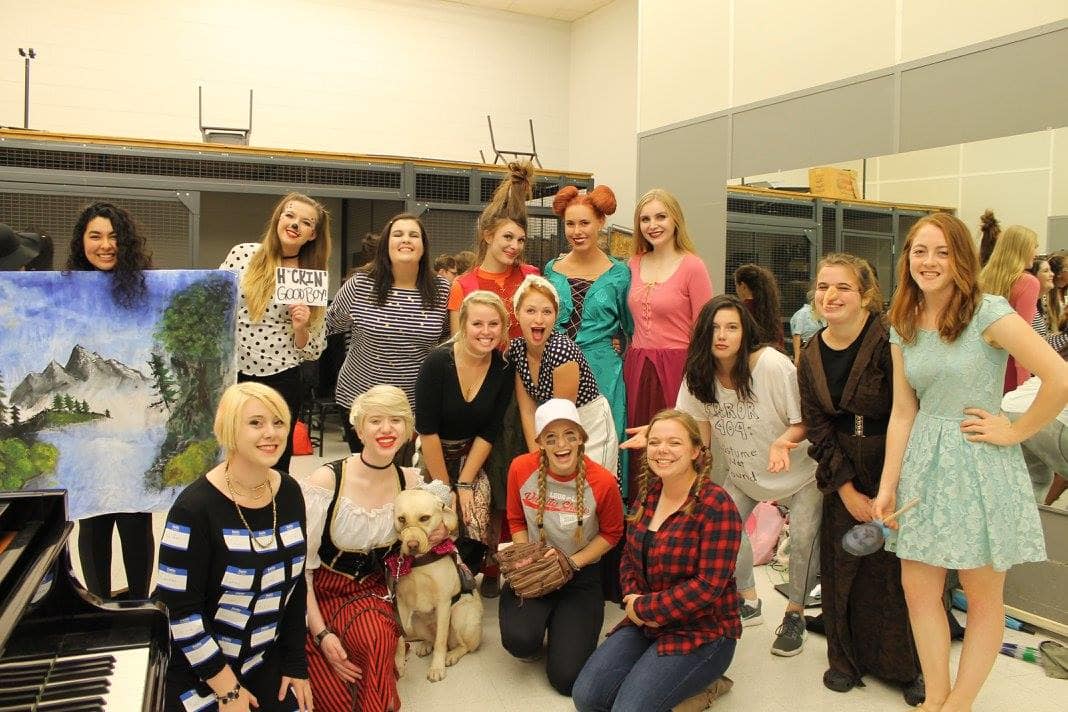 The Second Soprano Women's Glee Club section smiling for a photo at the annual Halle-BOO-jah concert