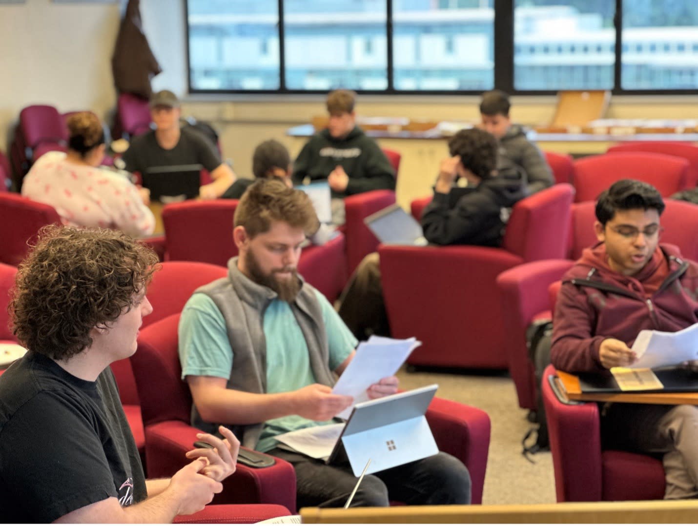 People sit in groups to work on projects