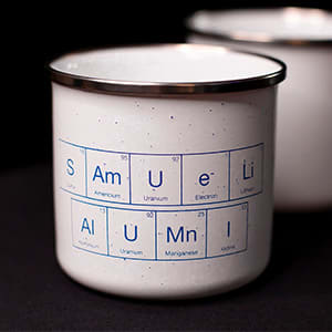 white metal mug with Samueli Alumni blue lettering