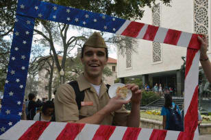 Man dressed in Military clothing posing with a pie