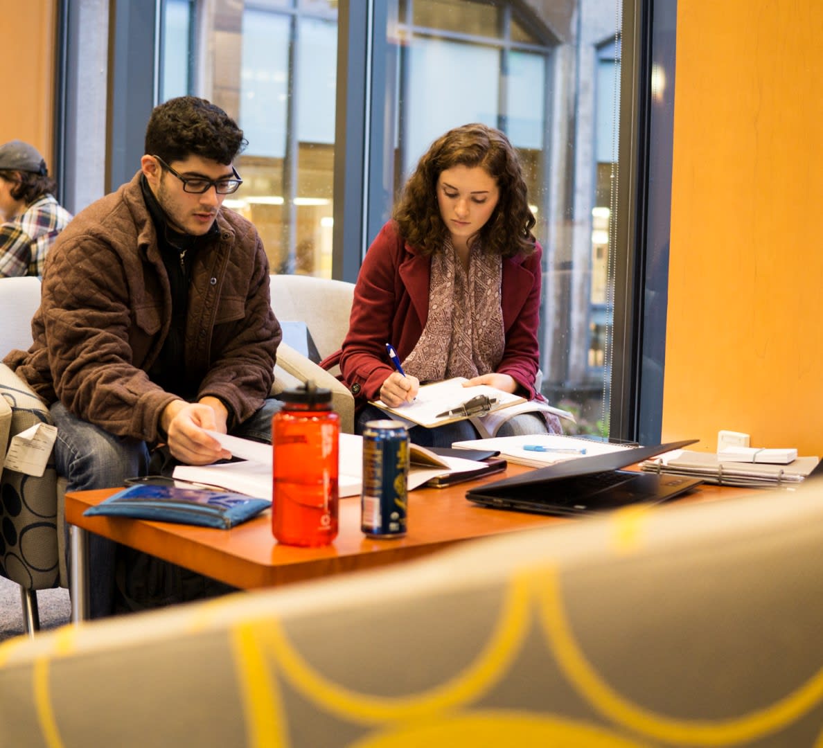 Two students studying in the Mann Family Skybridge of Wilson Library