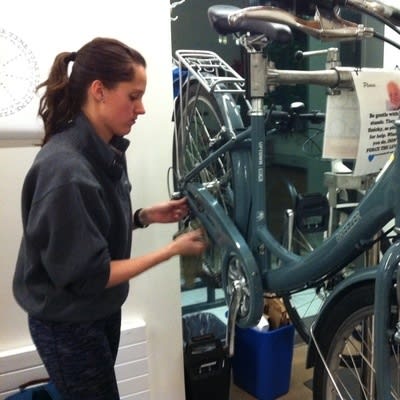 A person fixing a bicycle

Description automatically generated