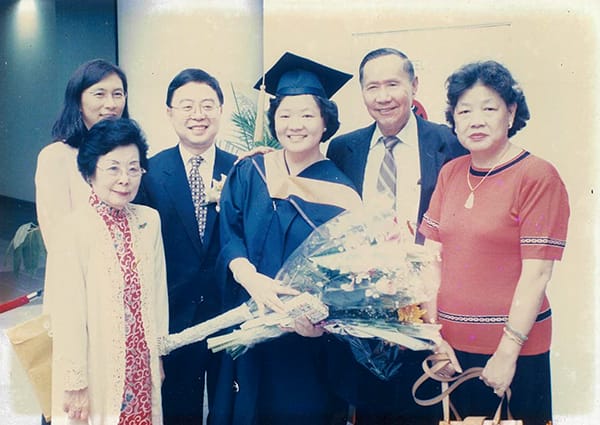 Graduate and family celebrate graduation.