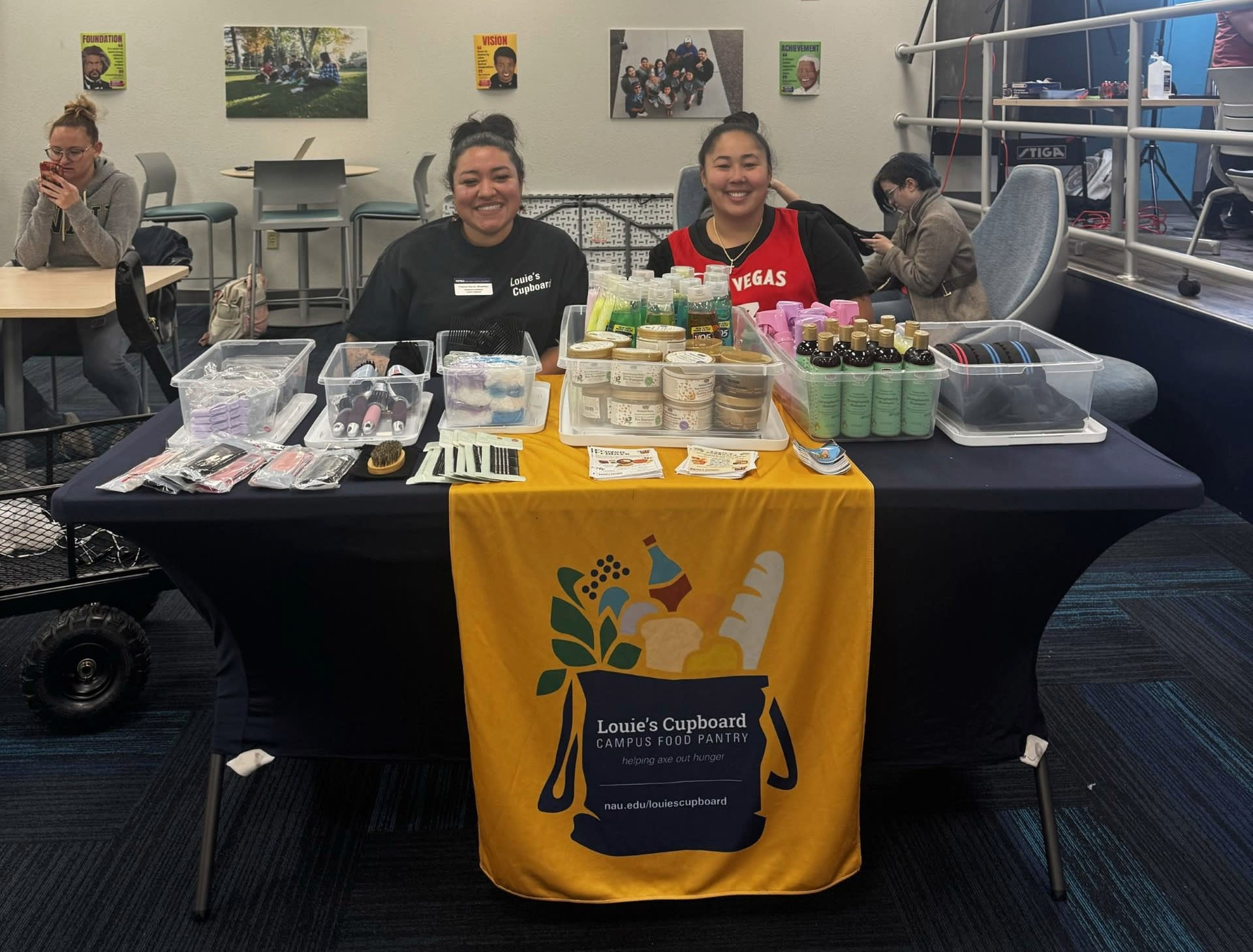 Two students working the Louie's Cupboard booth.
