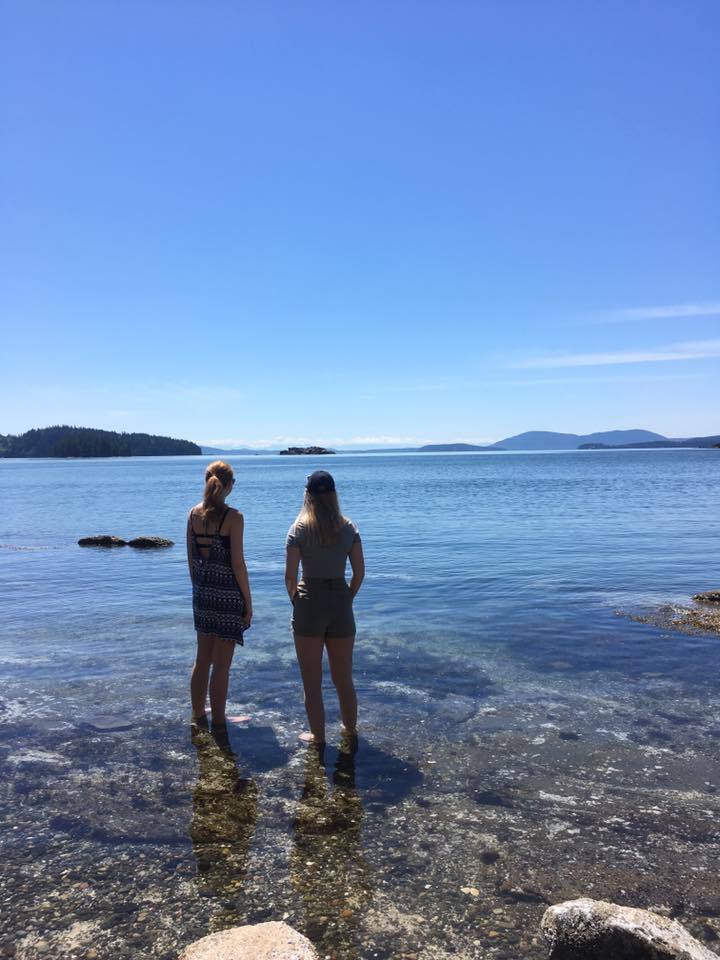 Image may contain: one or more people, people standing, ocean, sky