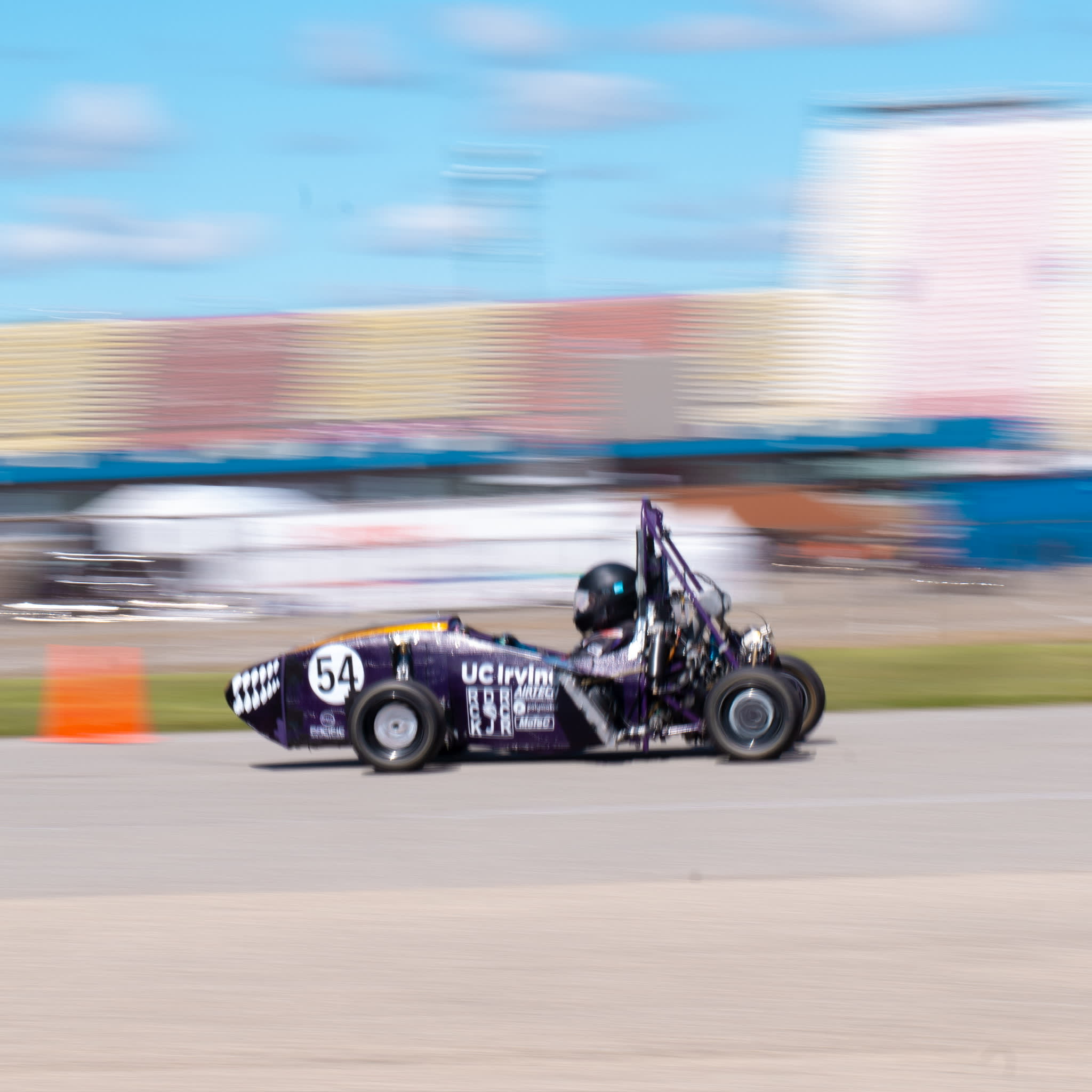 Action shot of the Anteater Formula Racing car driving on a track.