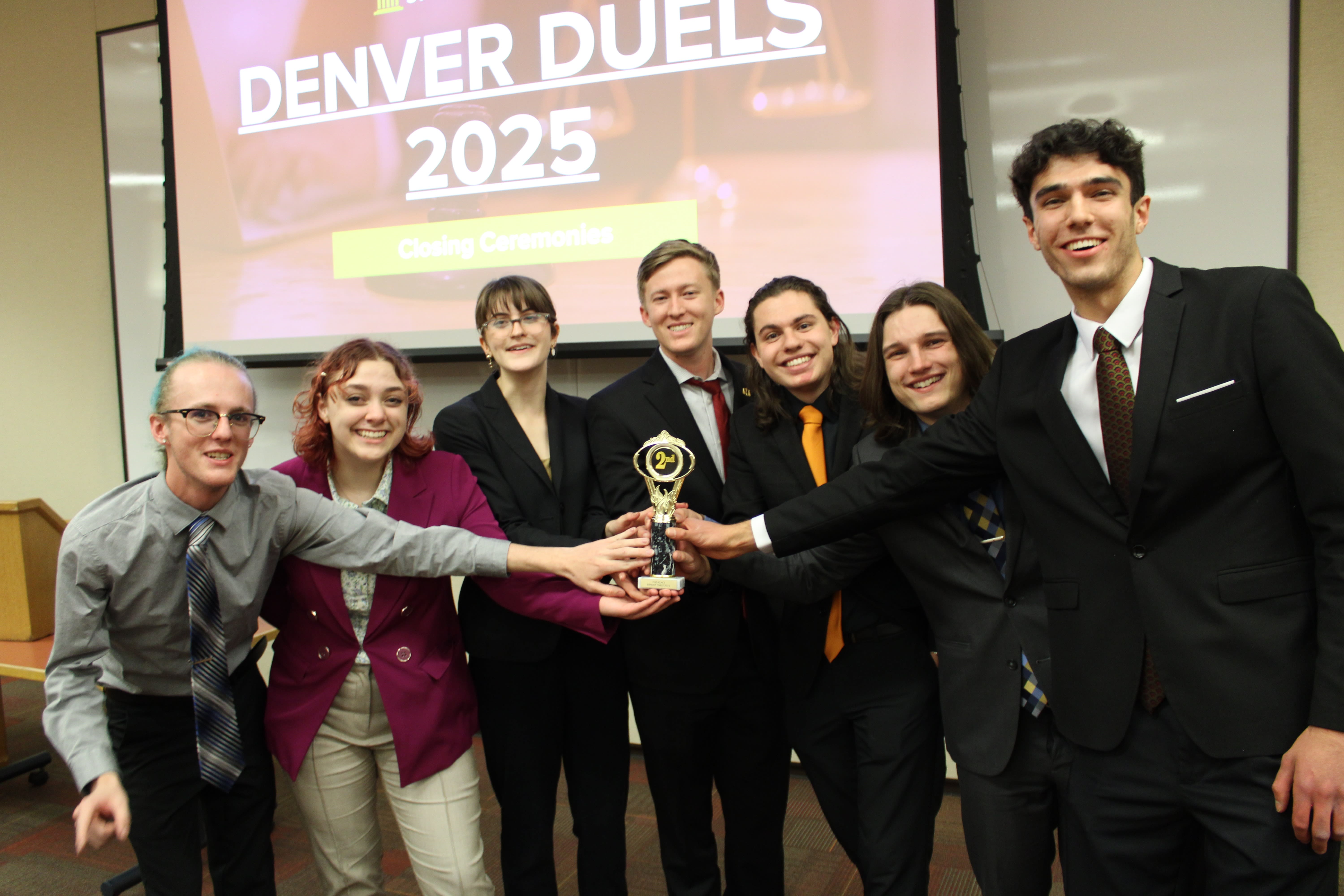 NAU Mock Trial members holding a trophy
