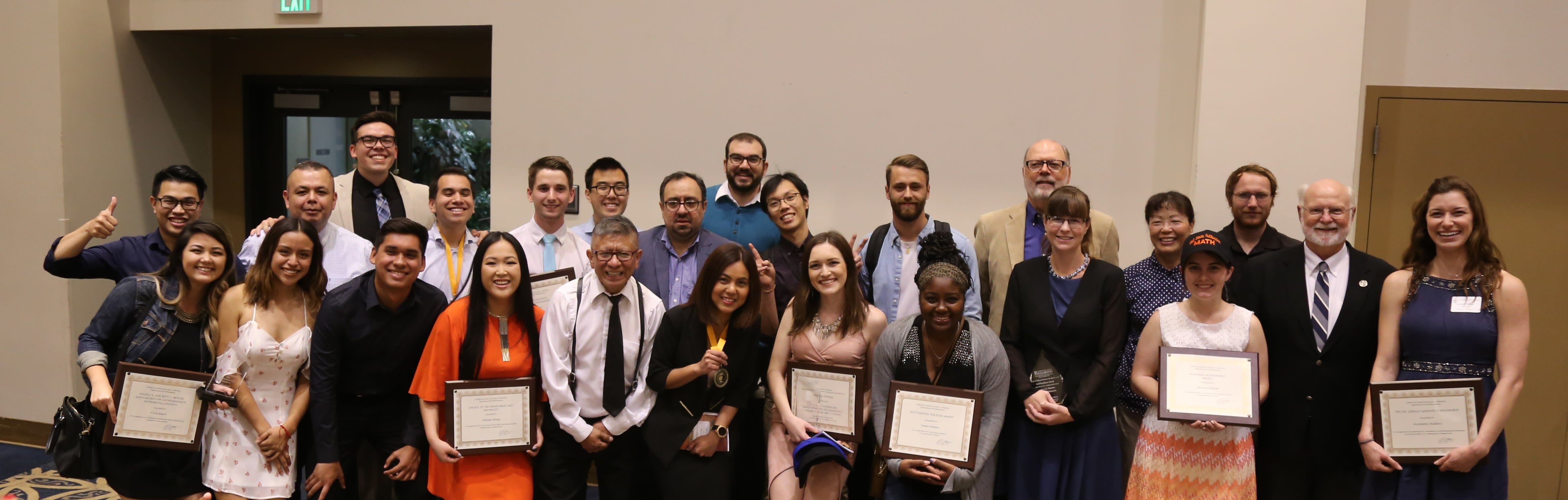 students at a conference holding certificates