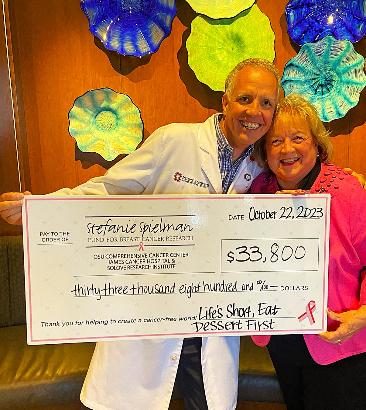 Dr. Skoracki and Paula Brose holding a large check of $33,800 for The James