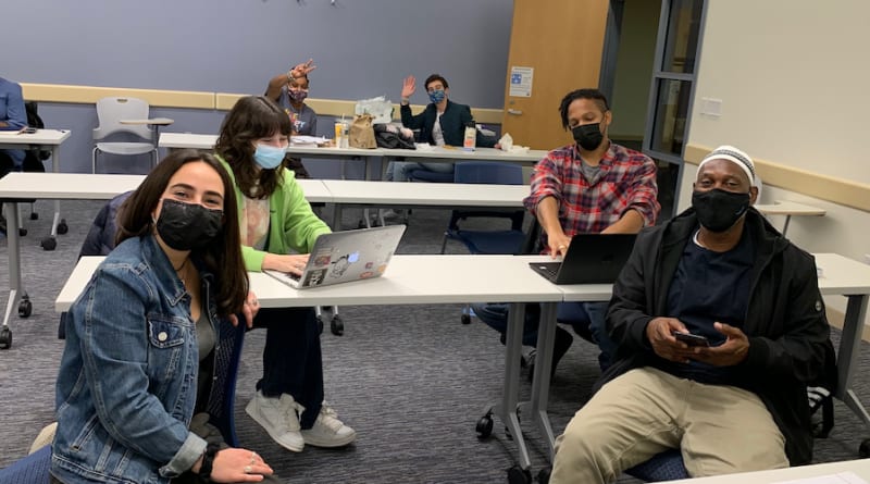 A picture containing person, indoor, people, group

Description automatically generated