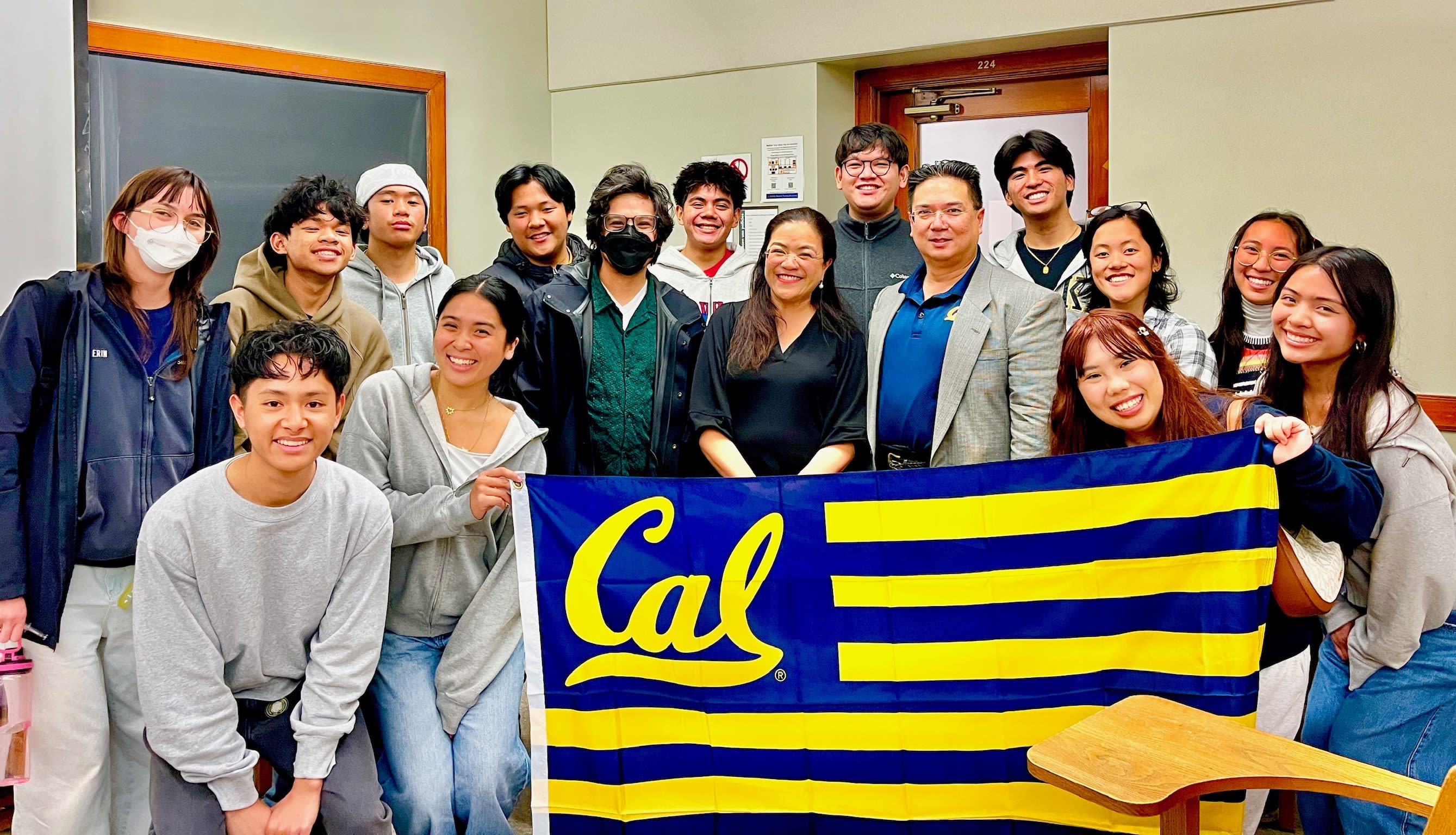 PAHC students smiling and holding a Cal flag.