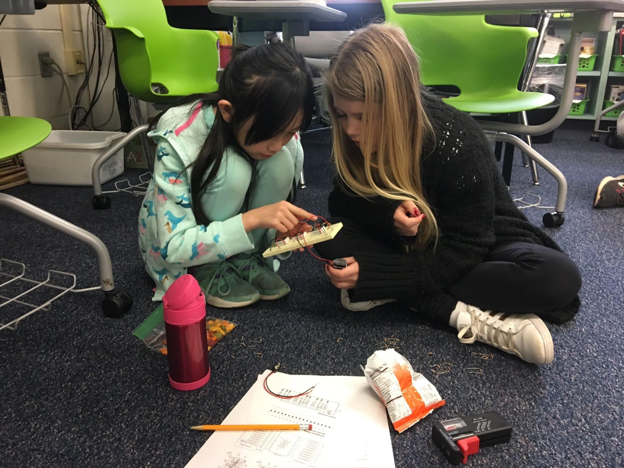 Two students from Norwich Elementary building a display to light up their initials.