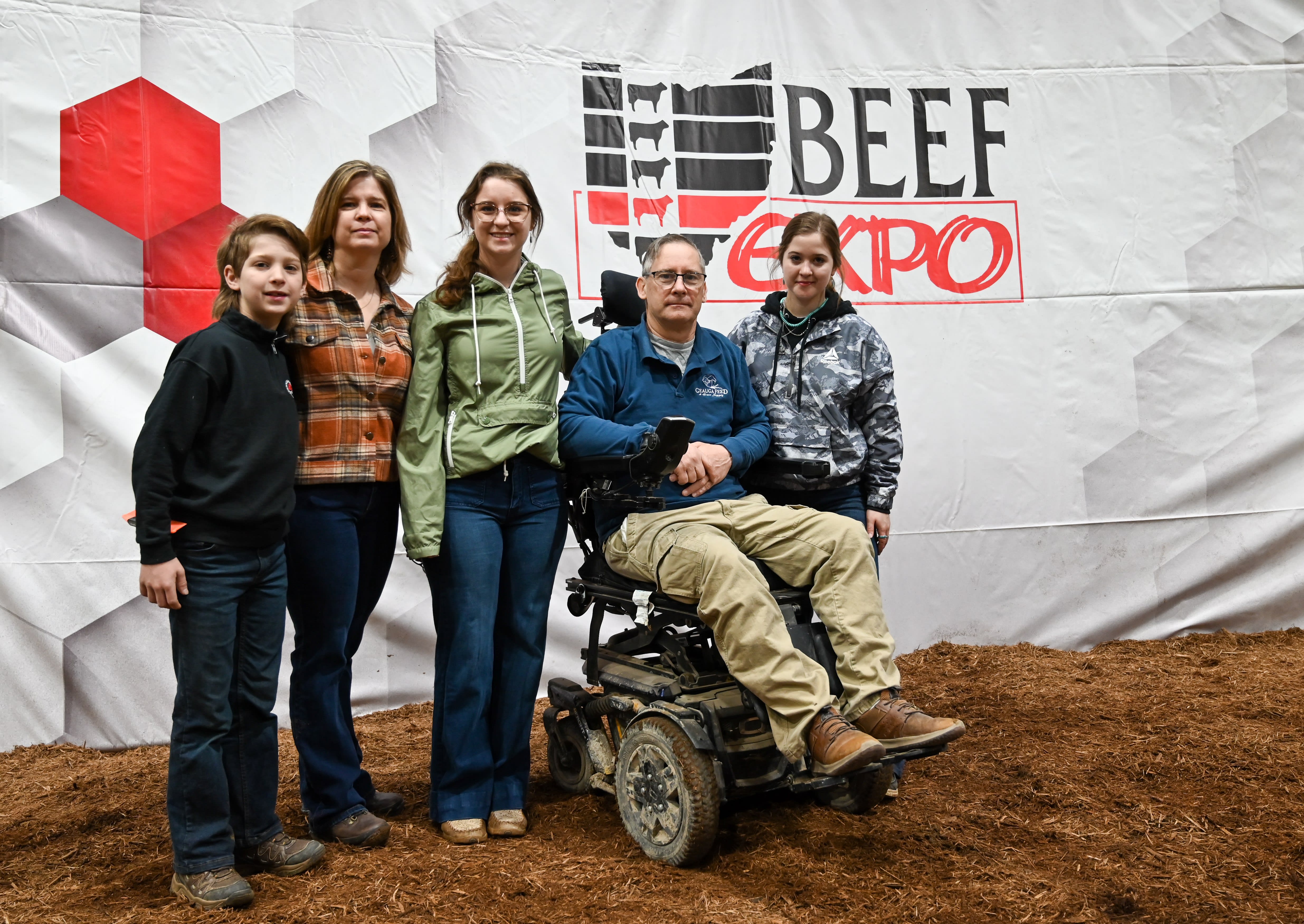 Five members of the O'Reilly fanily stand before the Beef Expo backdrop