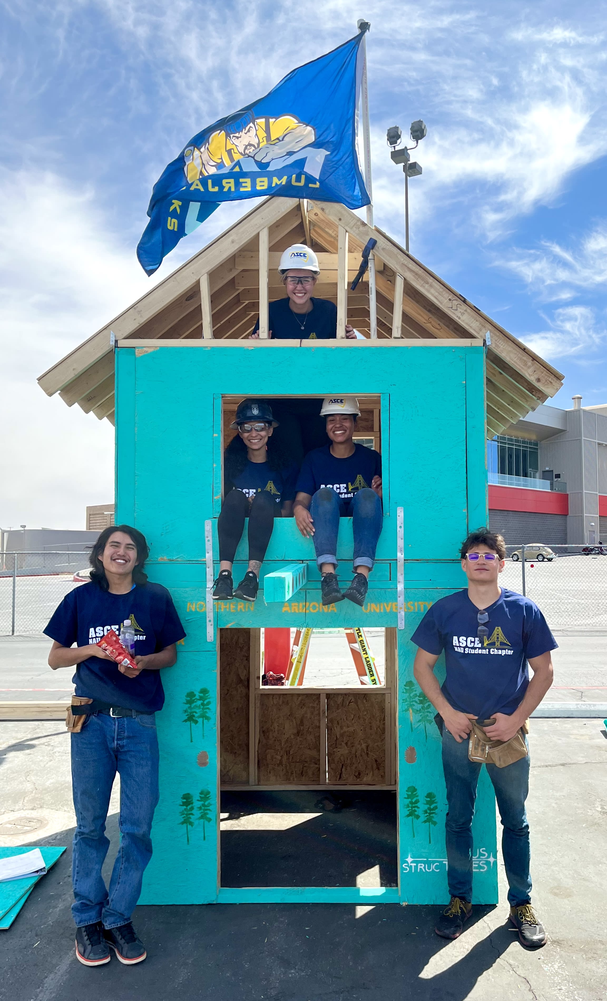 A group of people standing in a small house

Description automatically generated