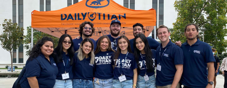 Daily Titan students in Daily Titan t-shirts standing together