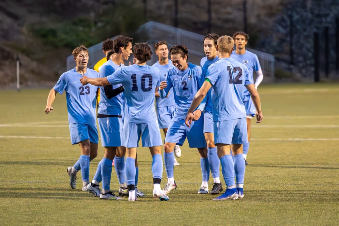 A group of men in blue uniforms on a field

Description automatically generated