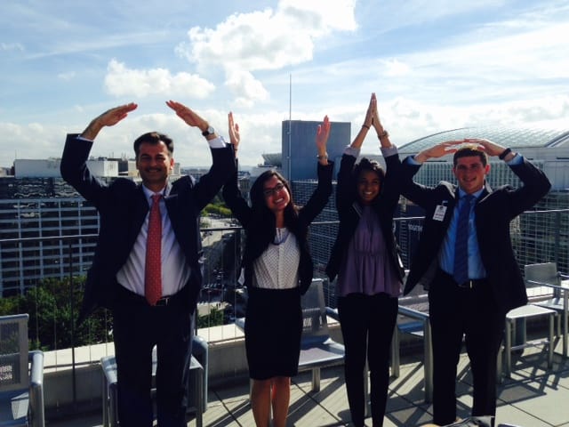 Four students posing OHIO on a rooftop in a city