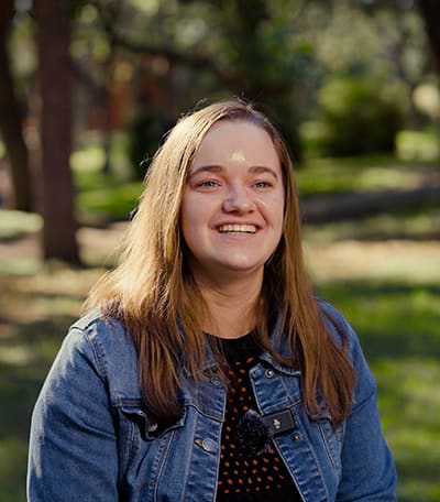 Erin Pake with trees and lawn in the background
