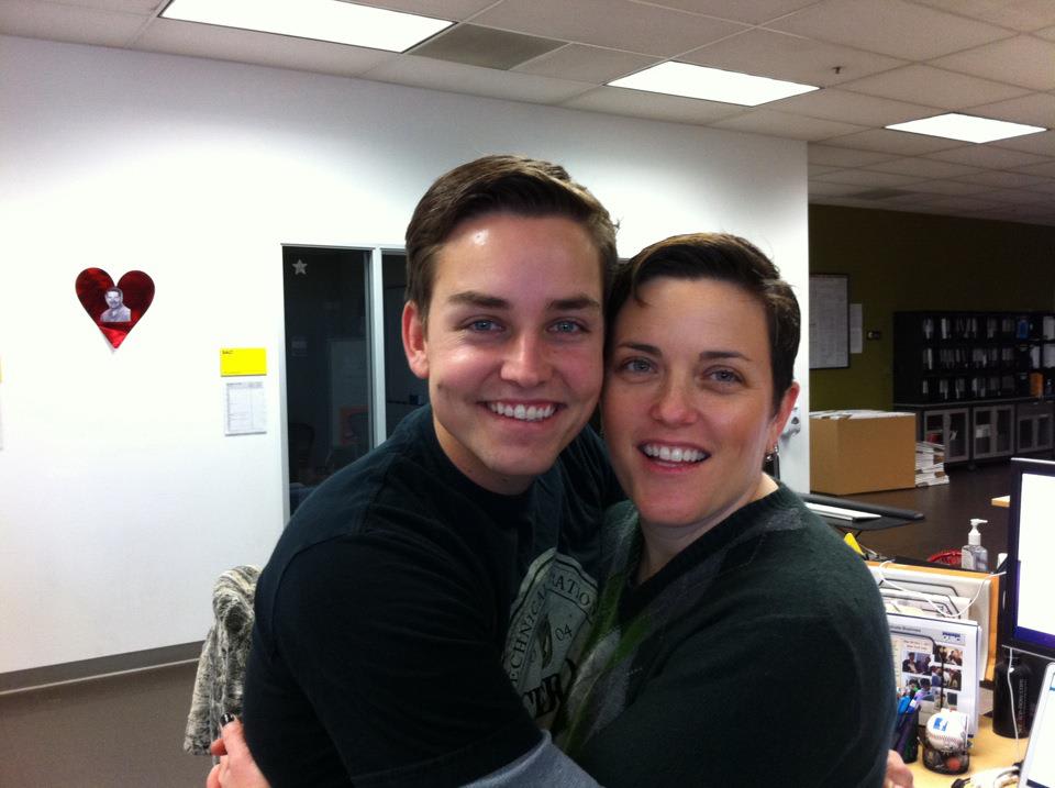 Dale and Sara from the LGBT Resource Center hugging each other.