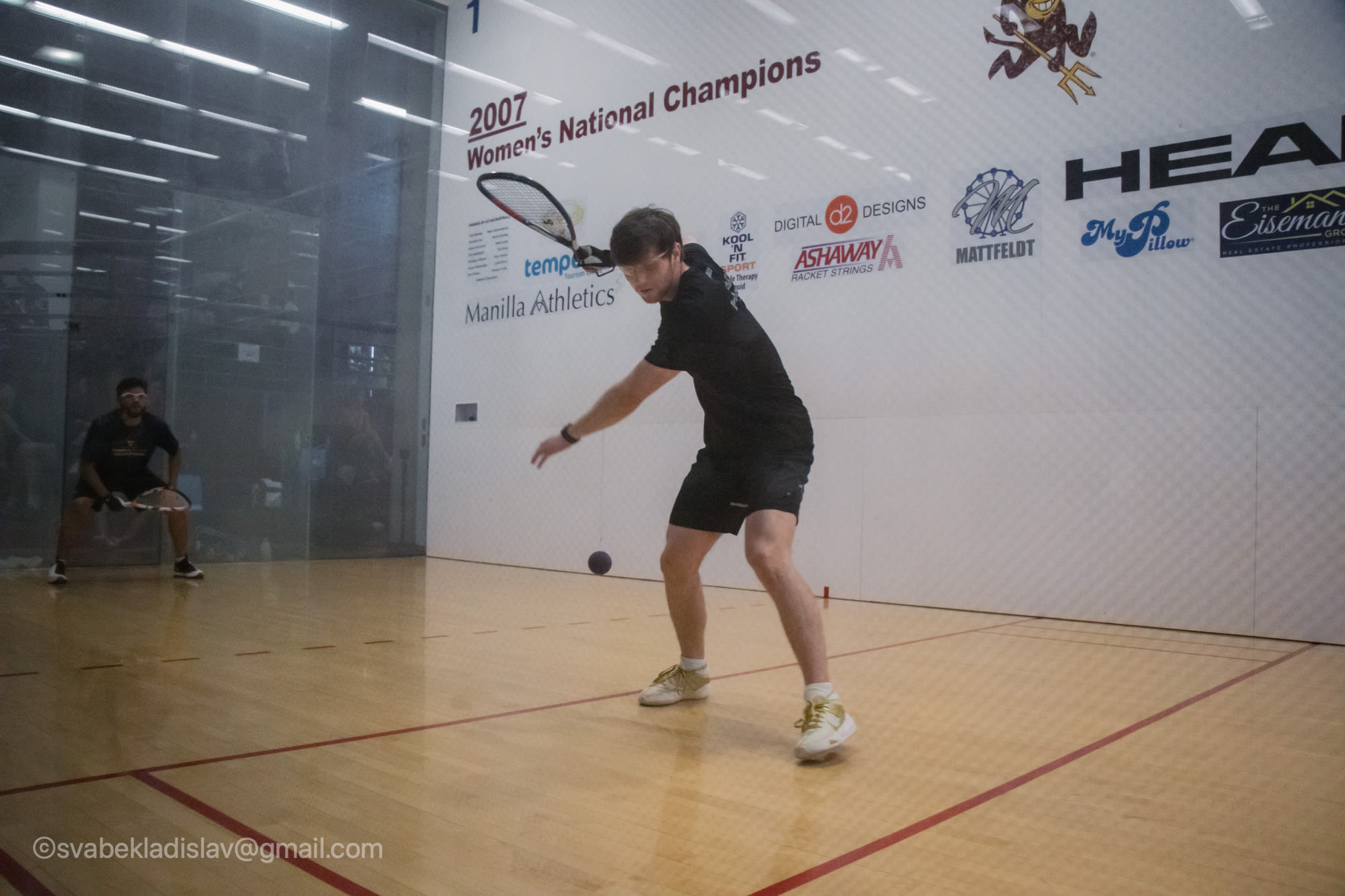 Racquetball member playing on court