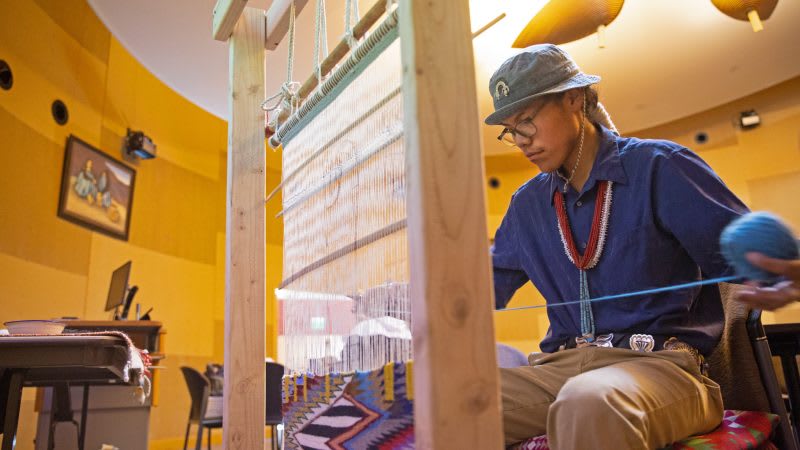 A person weaving a loom

AI-generated content may be incorrect.