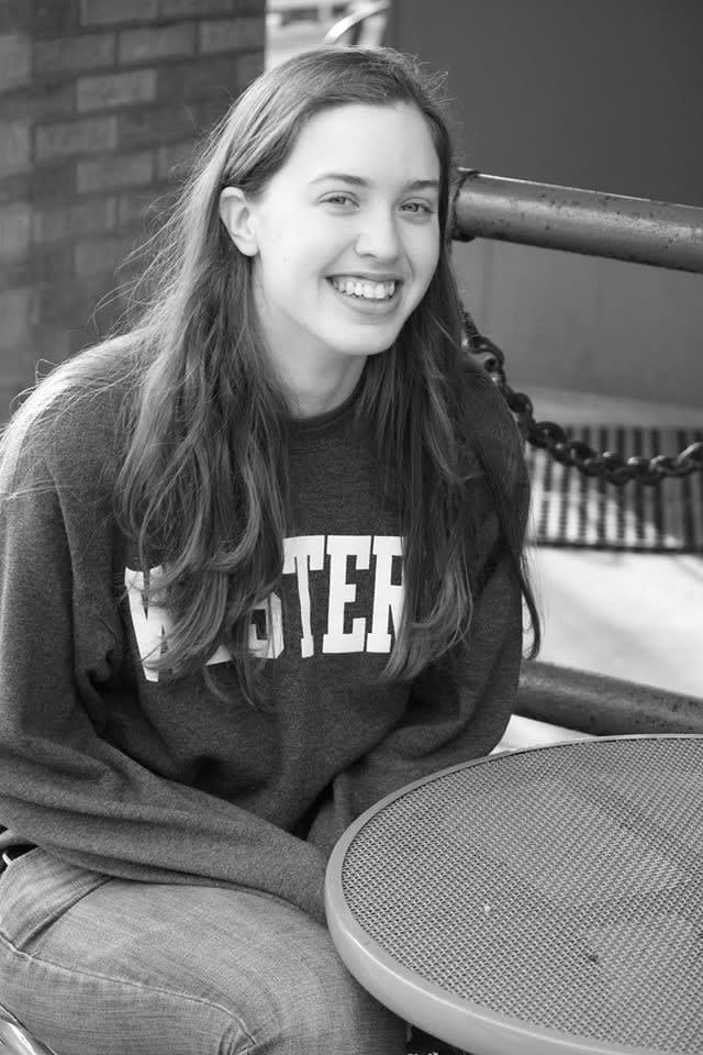 Meagan Elizabeth Smith wearing a Western sweatshirt and smiling