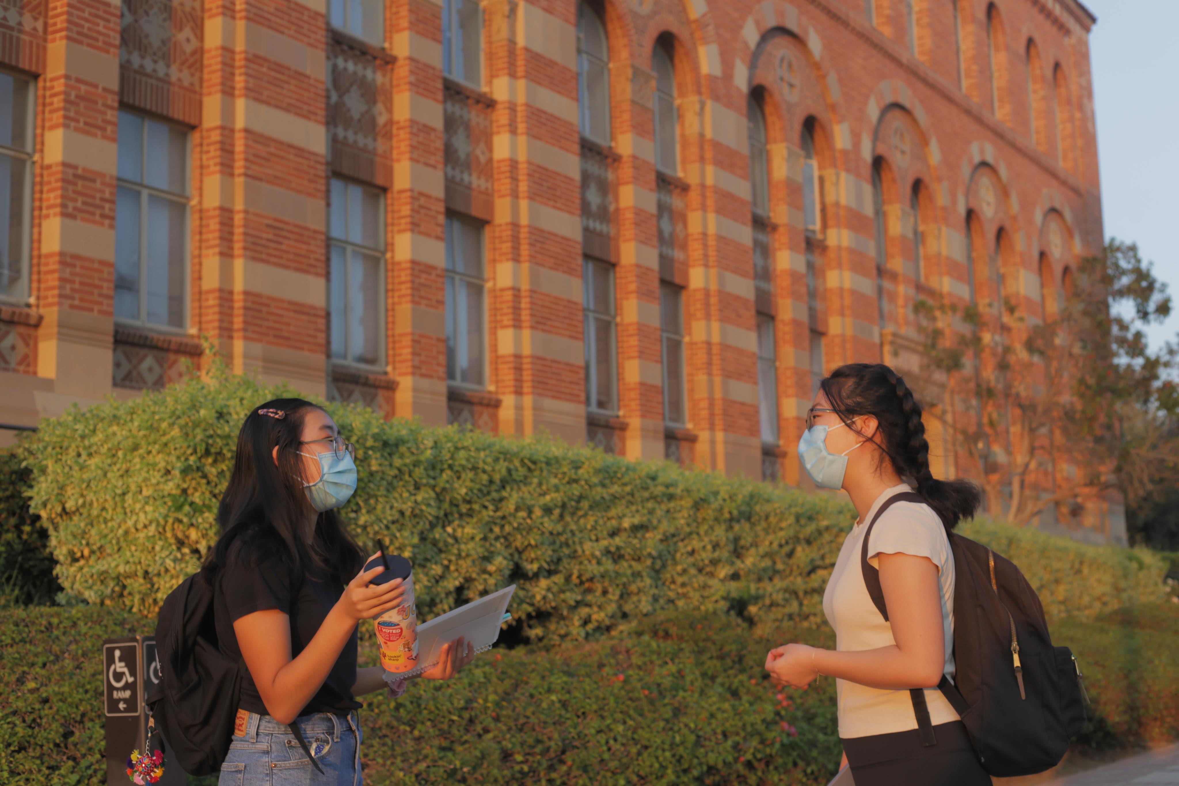 Two students talking in front of Haines Hall.